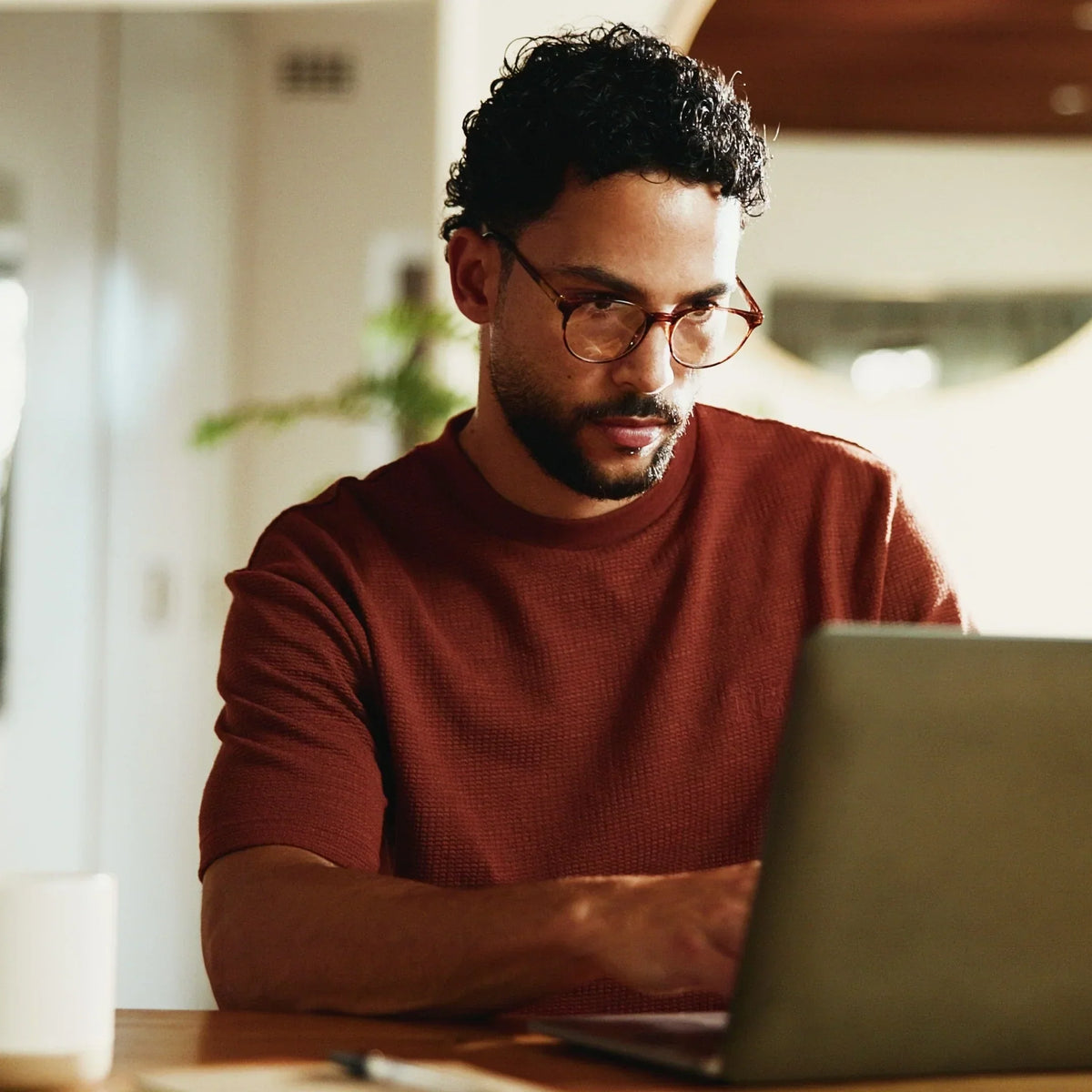 Person working alone and focused on a laptop, with no one else on the call.